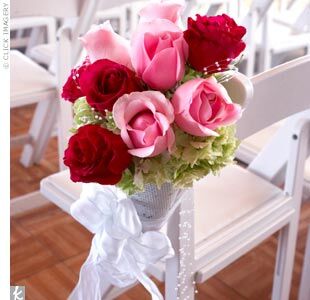 The couple chose not to use any greenery in the wedding day flowers and opted for arrangements consisting of hydrangeas, cymbidium orchids, roses, and stephanotis.