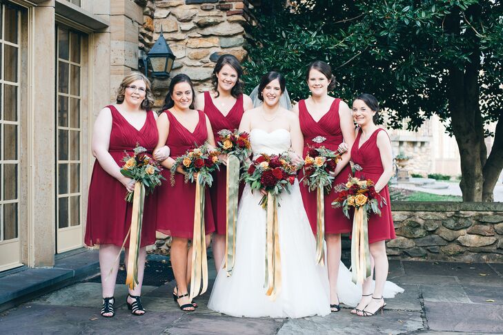 Ellie's bridesmaids wore short A-line dresses with v-necklines in a dark shade of cranberry.