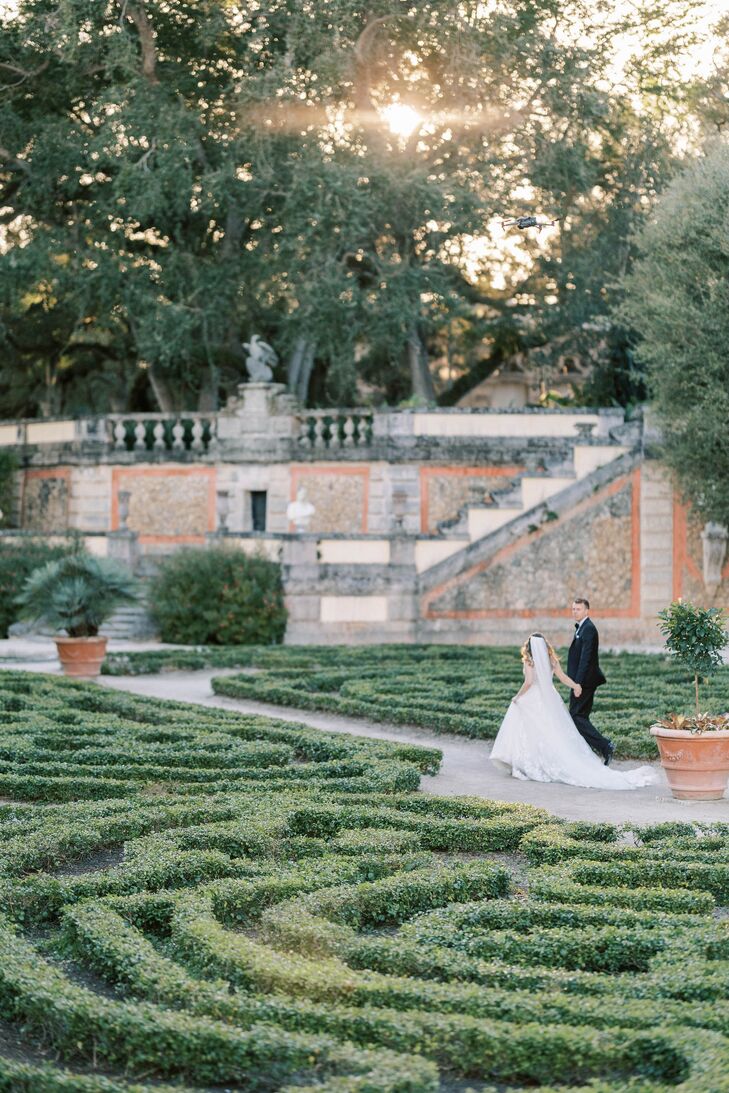 Bride With Cathedral-Length Veil and Full A-Line Gown With Groom in Tux in Formal Estate Garden