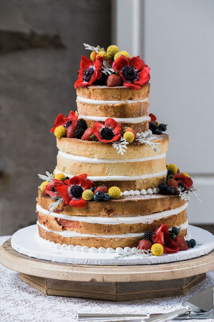 The couple wanted a summer themed cake, so Bredenbeck's created a lemon raspberry cake layered with vanilla buttercream. In addition to fresh fruit accents, Anemones and craspedia flower clusters were added to the cake by La Petit Fleur.