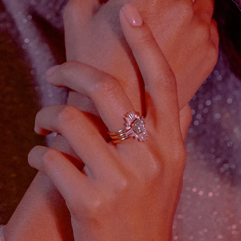 multi-shaped diamonds in petal design around center stone