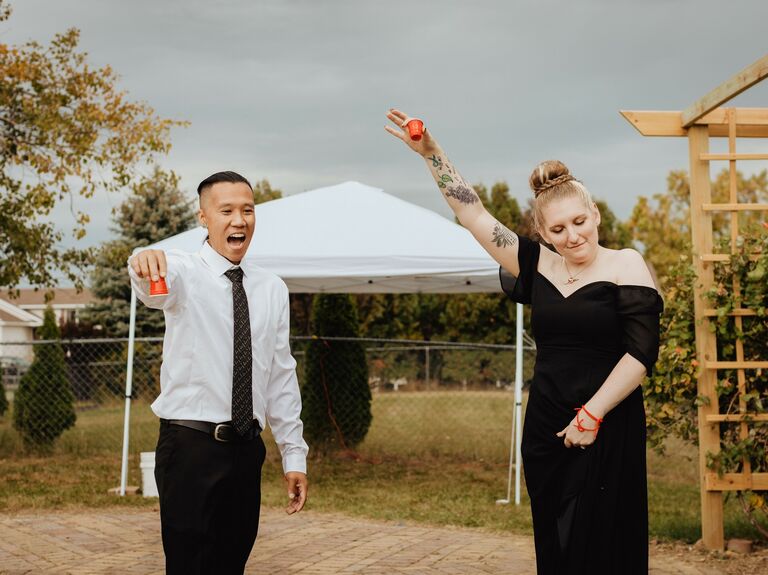 Couple raises their glasses in a toast. 