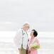 Bride in Traditional Pink Tang Suit and Groom in Casual Attire With Leis at Vow Renewal