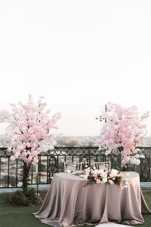 Sweetheart Table Flanked by Cherry Blossom Arrangements