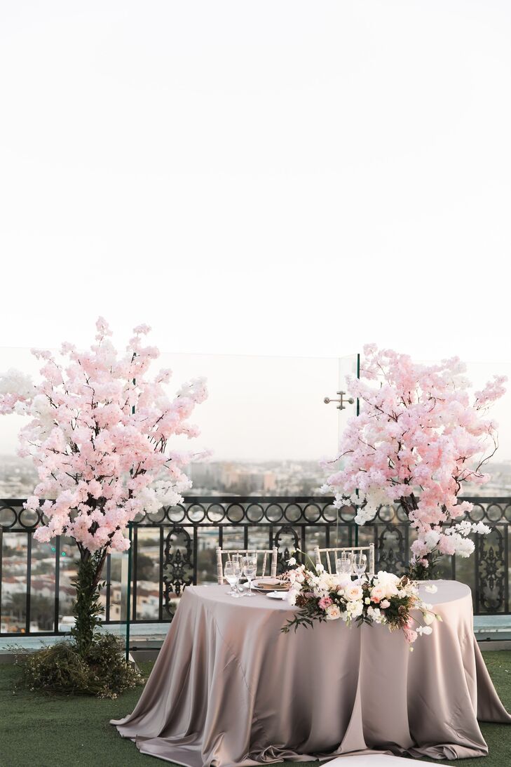 Sweetheart Table Flanked by Cherry Blossom Arrangements