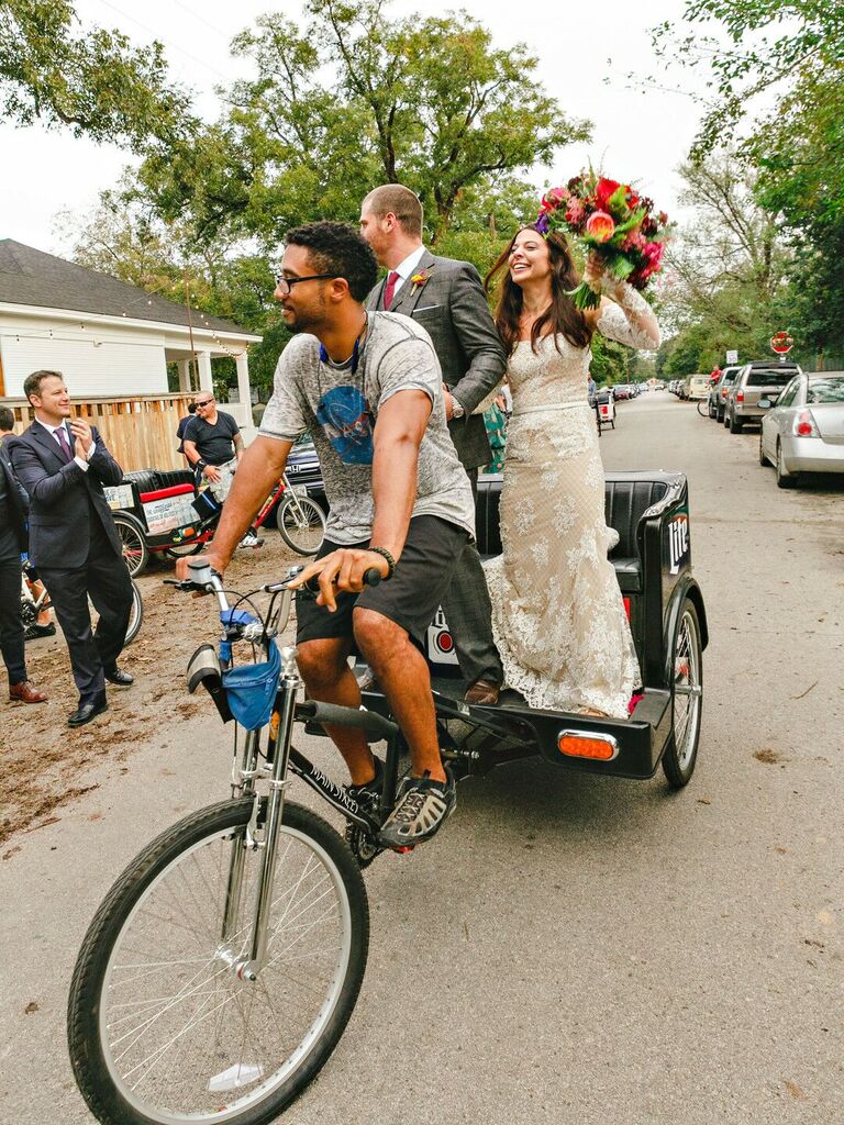 Bride and groom riding in a pedicab. 