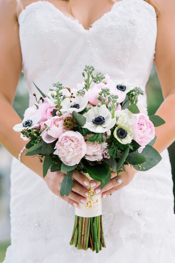 “I wanted a loose, organic, natural look for the bouquet,” Lona says. She carried pink peonies, pink ranunculus and white anemones wrapped with ivory satin and decorated with her grandmother's broach.
