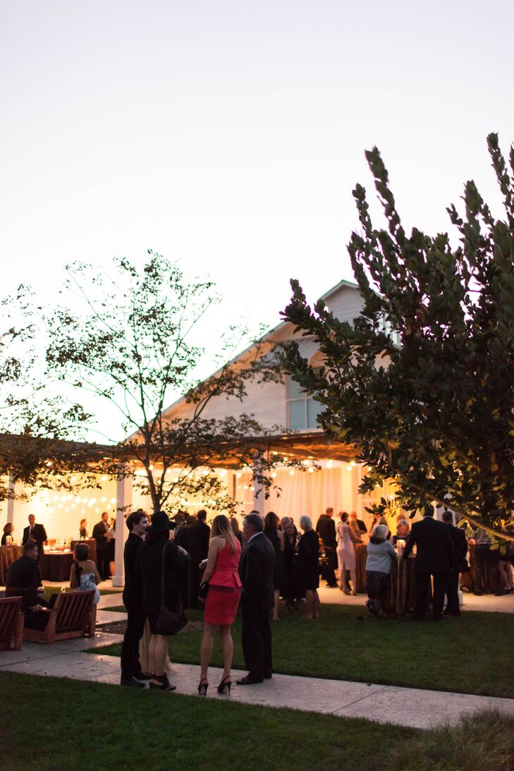 Kendal and Christopher loved that their venue had both outdoor and indoor space. The warm day allowed for the ceremony to be held outdoors before guests moved to this semi-outdoor space for the cocktail hour.