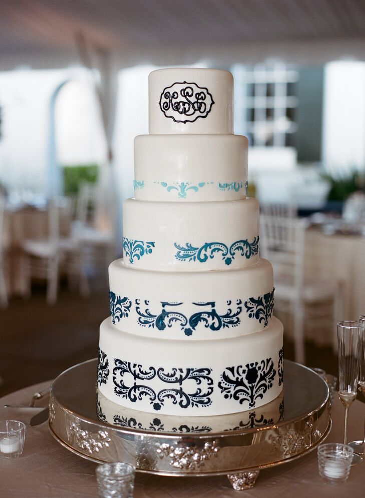 Kathryn and Cal's wedding cake was five tiers of white fondant decorated with blue piping in a damask style.