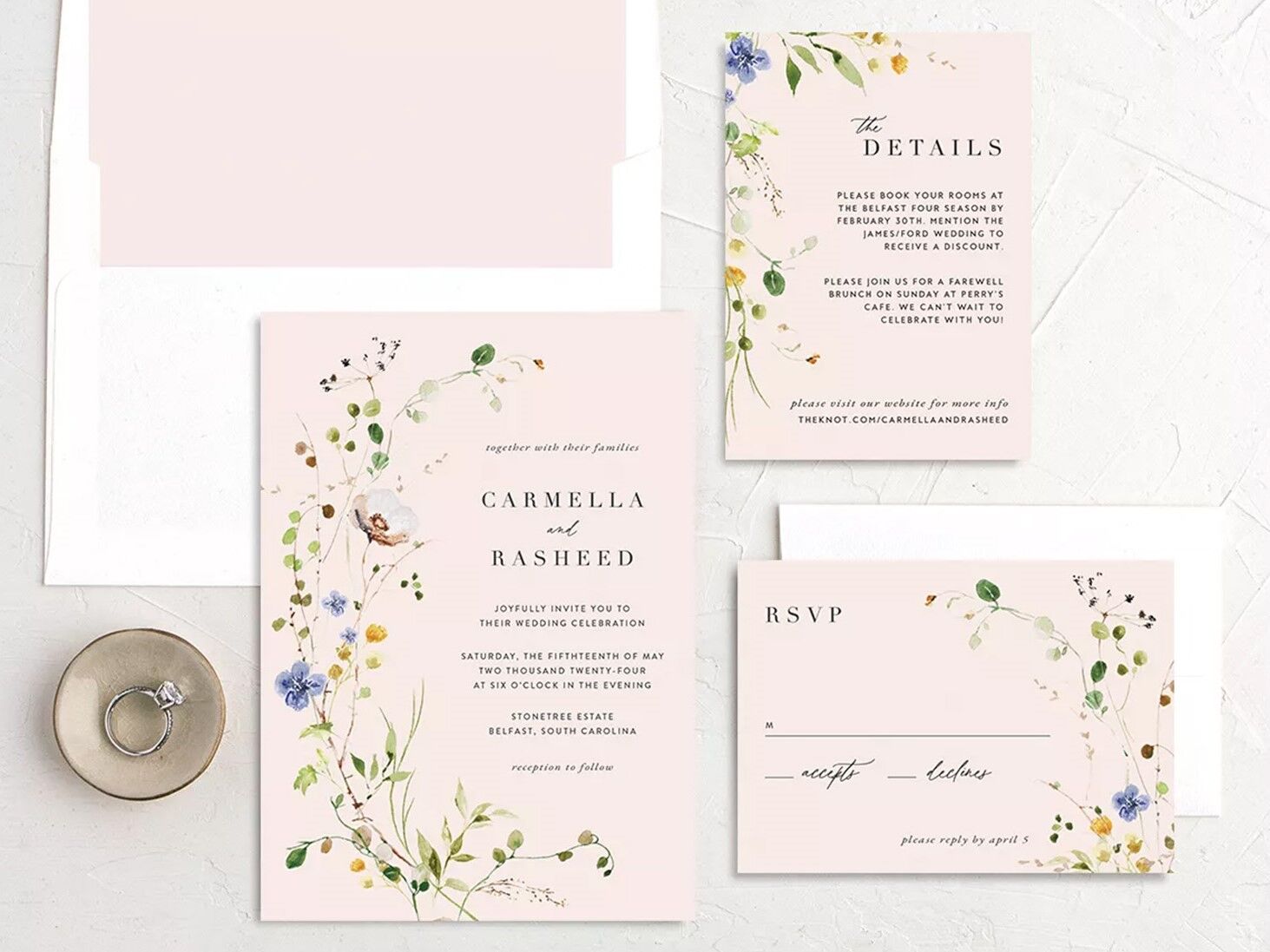Neutral toned wedding invitations with floral accents.