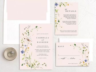 Neutral toned wedding invitations with floral accents.