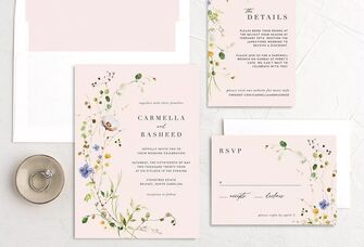 Neutral toned wedding invitations with floral accents.