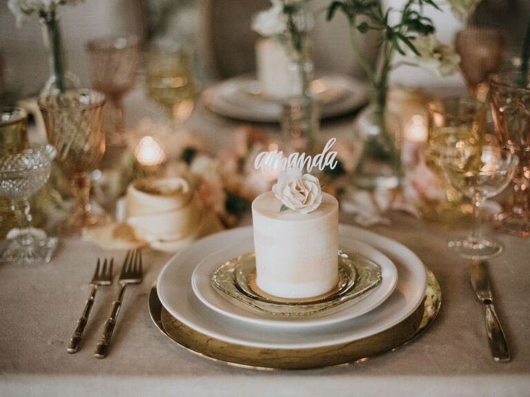luxury wedding place setting featuring miniature one-tier cake decorated with amanda cake topper in lieu of place card