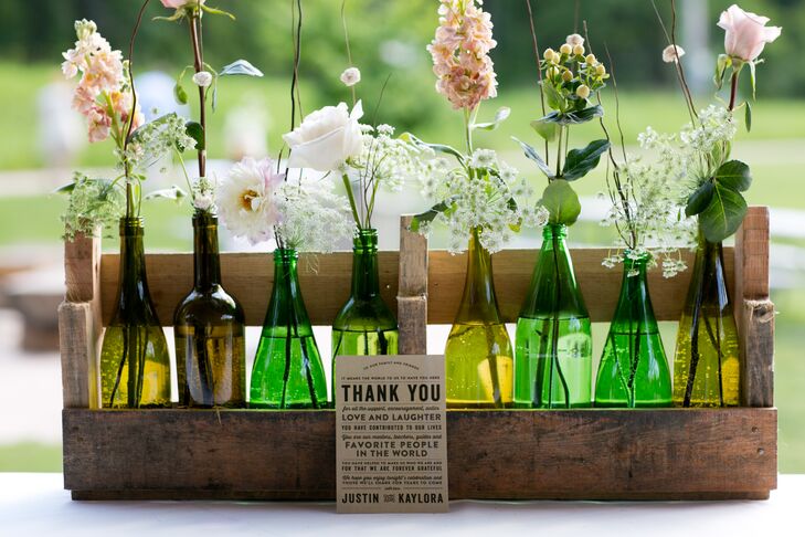 An assortment of roses and wildflowers were displayed in bud vases for a rustic, relaxed look.