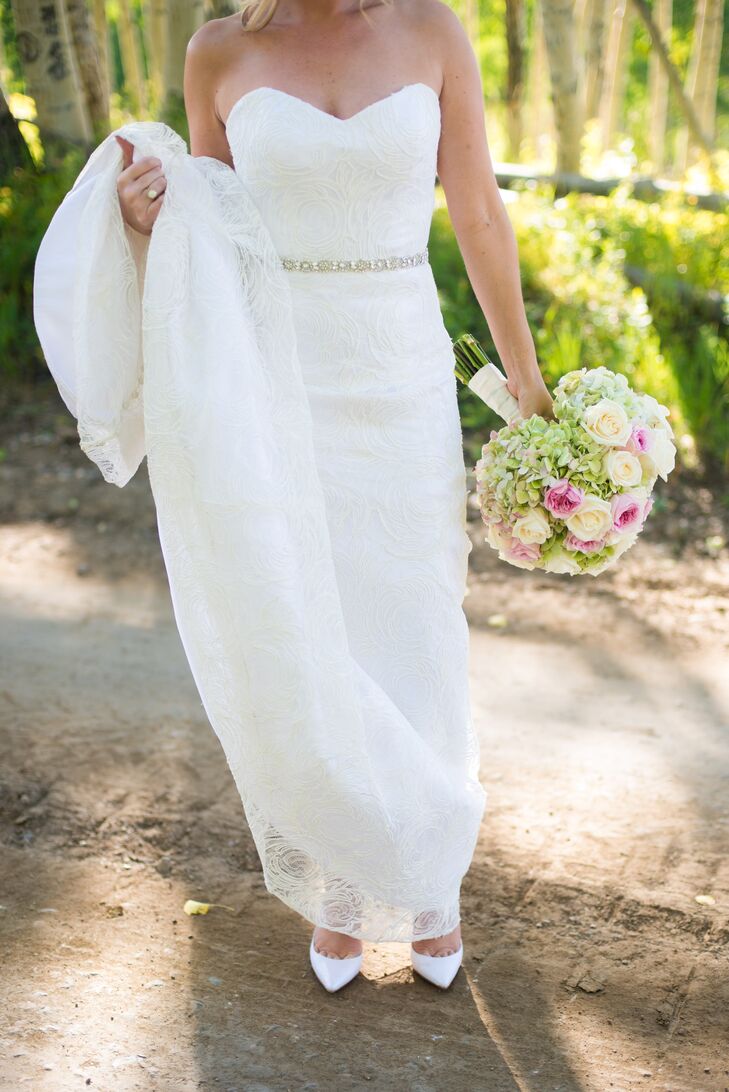 Ashley wore a floral French lace wedding dress with a fluted skirt, double charmeuse under gown and a crystal belt.