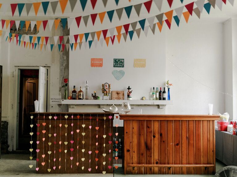 Bar space with colorful bunting and streamers for a whimsical wedding reception