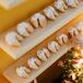 Fortune Cookies Dipped in Frosting and Sprinkles on Bright Escort Display