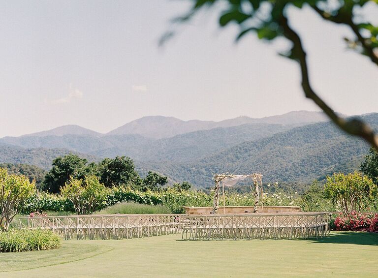 Outdoor wedding ceremony with mountain backdrop