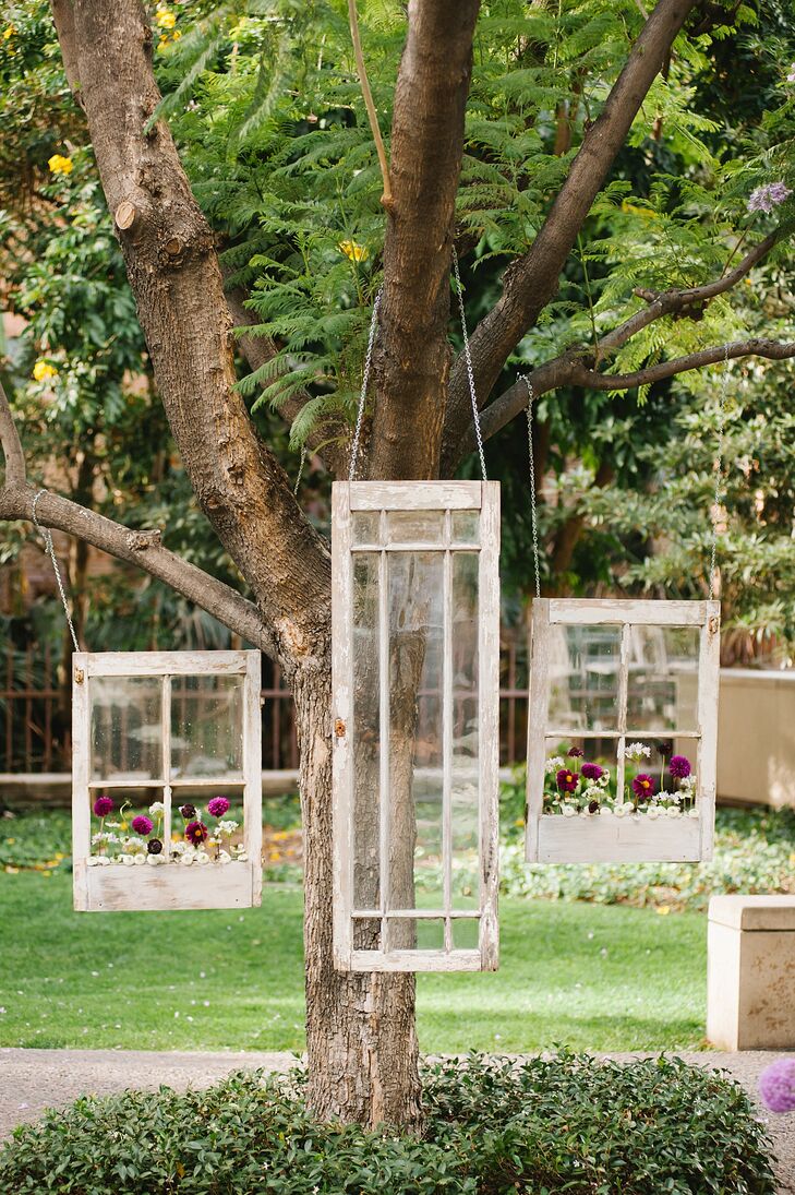 In lieu of an alter, the couple chose to hang vintage windows with flower boxes as the focal point of the ceremony.