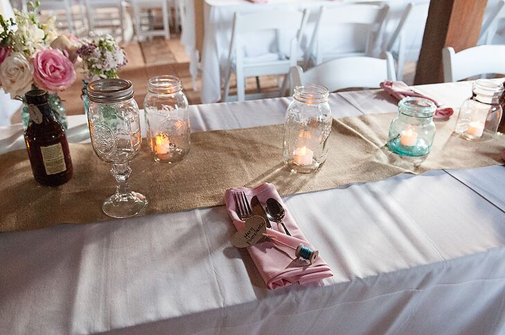Mary and Sam's long, rectangular dinner tables were lined with burlap table runners and glass mason jars filled with either battery-powered candles or pink and white flowers.