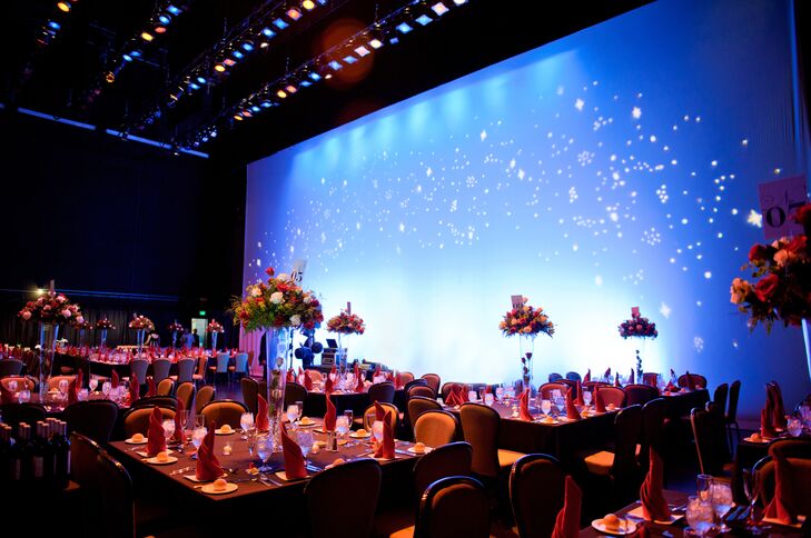 Dining tables for the reception were arranged on the Bushnell's stage. The backdrop resembled a starry night, and the area was illuminated with colorful spotlights.