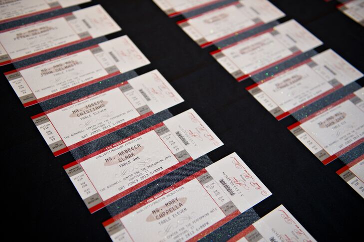 Escort cards at Nicole and Daniel's wedding resembled ticket stubs, which was fitting for their theater venue.