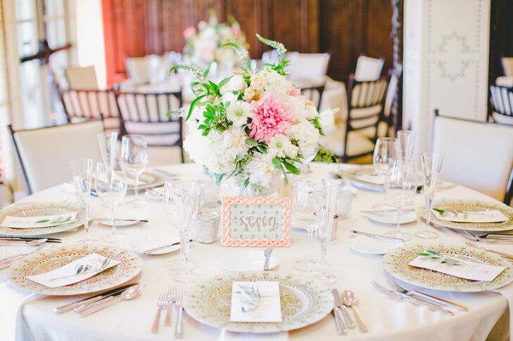 For the centerpieces, the couple's florist Michelle Jacob created textured, yet refined arrangements of scabiosas, hydrangeas, dahlias, stock flowers and Veronicas in shades of ivory and white, with pops of bright pink and peach.