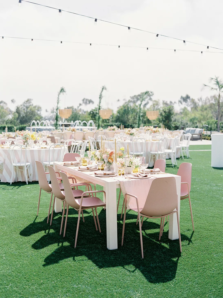These pale pink reception chairs add a playful element to a modern weddding.