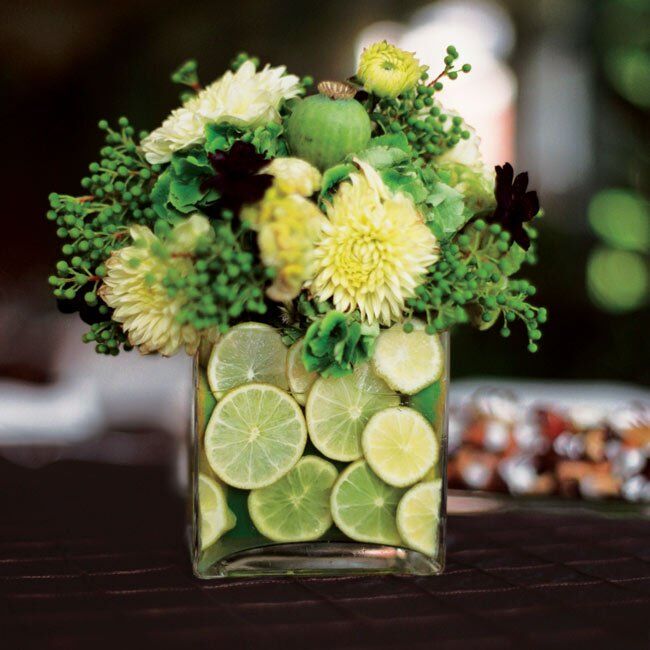 The third centerpiece was a square vase filled with lime slices and an arrangement of hydrangeas, cosmos, celosia, and dahlias, accented with berzillia and poppy pods.