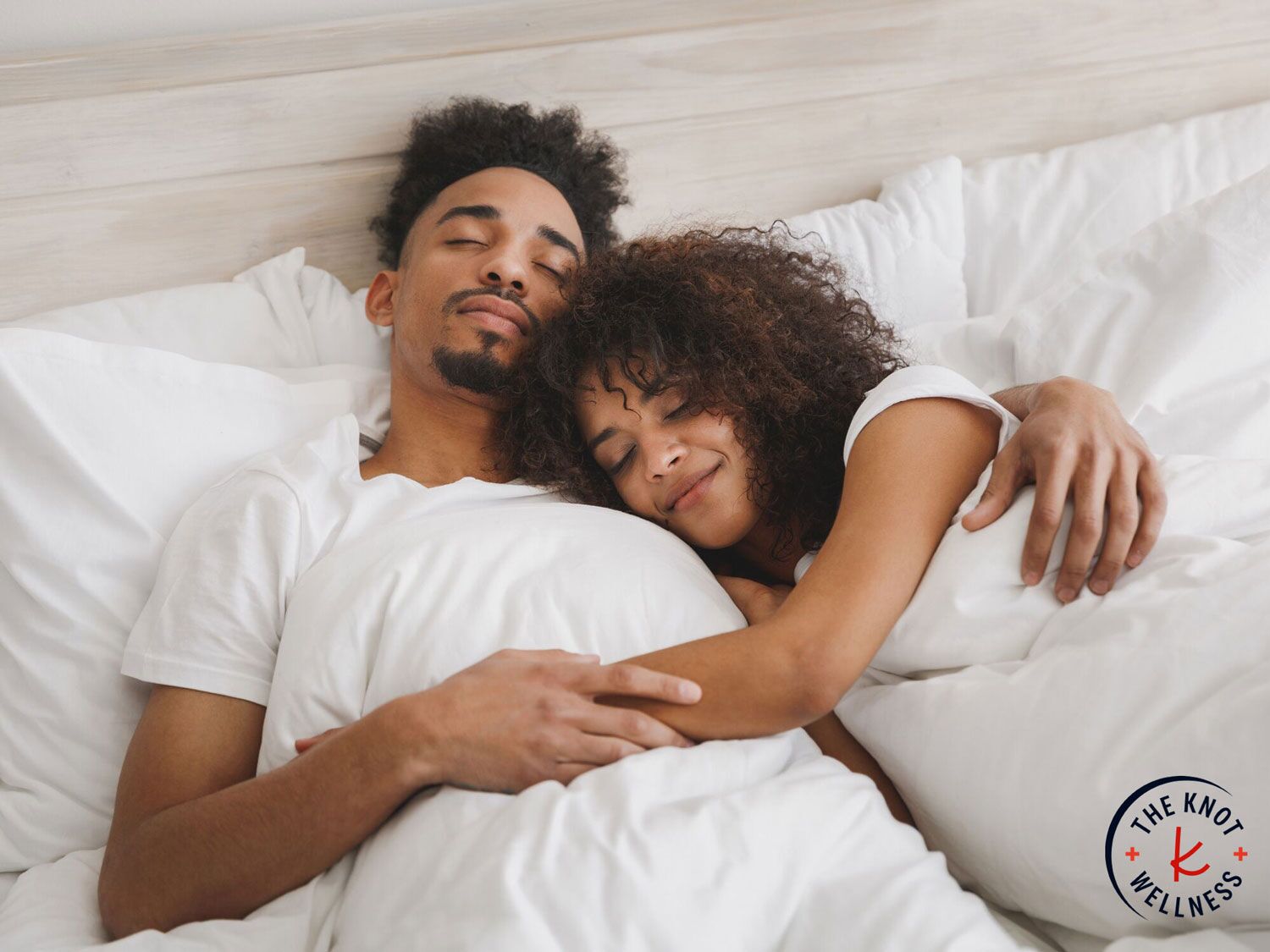 Couple cuddling on one of the best mattress for couples