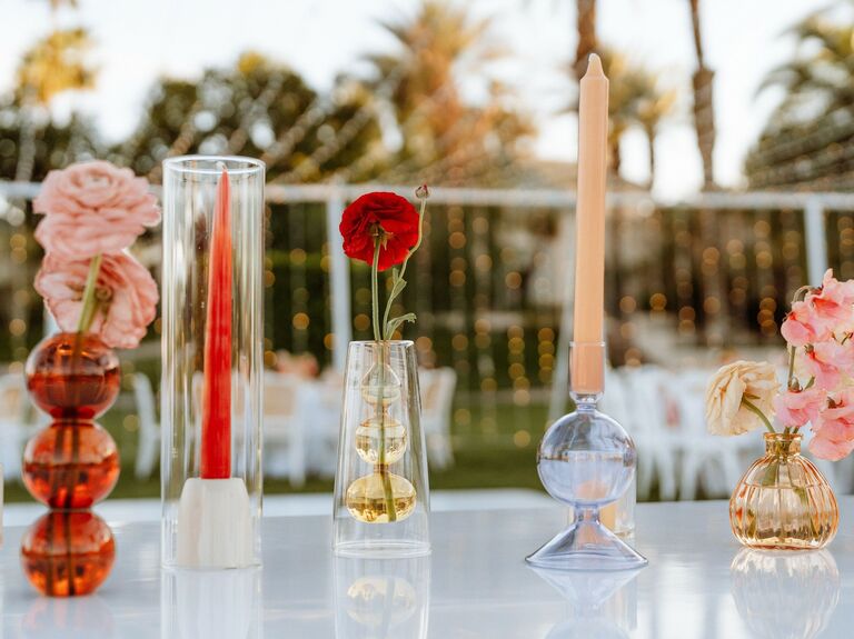 Two taper centerpieces with a red carnation.