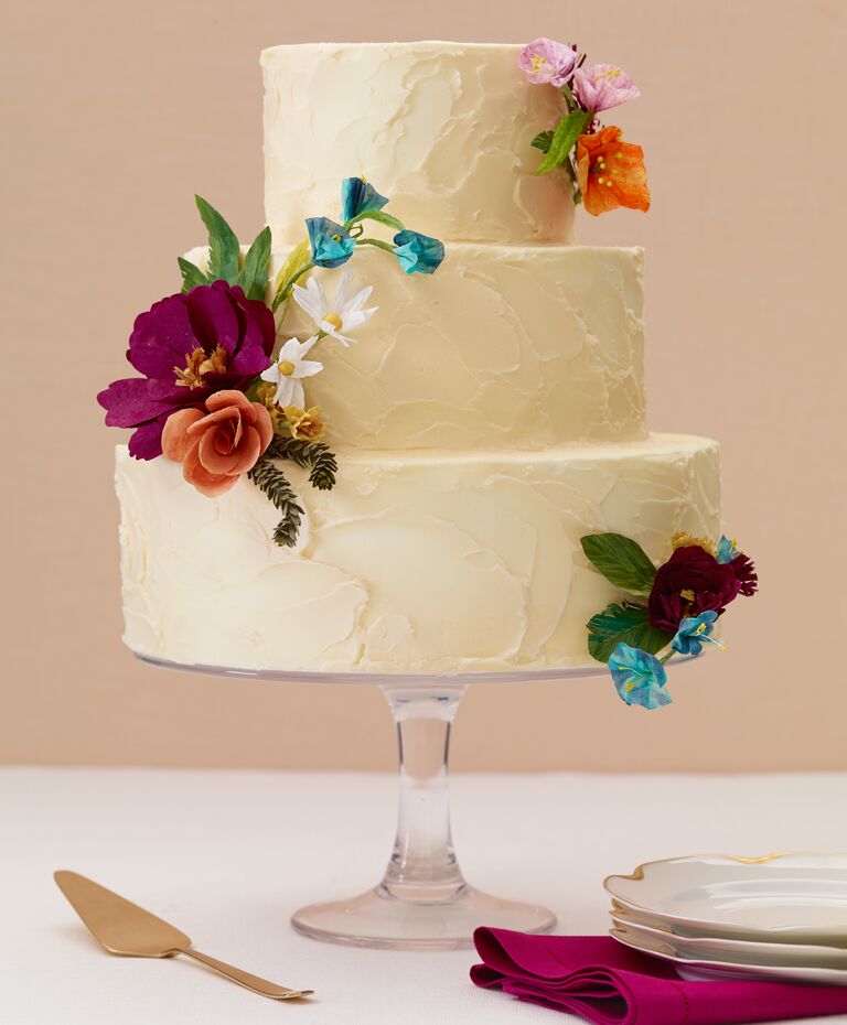 Round ivory buttercream cake with paper flowers