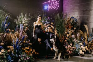 Couple in All-Black Wedding Attire Posing With Dog Beside Neon Sign