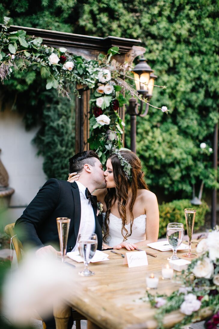 Beautifully draped in spring blooms, the ceremony arch later doubled as a bohemian backdrop for the sweetheart table.