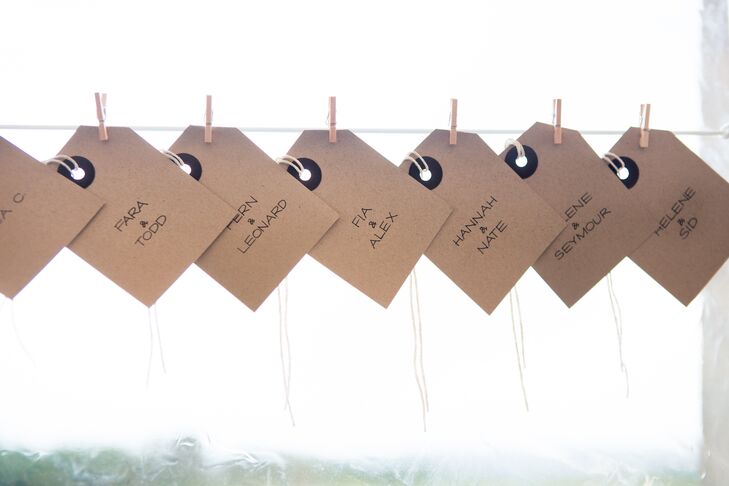 Escort cards were made of craft paper and hung with wooden close pins from white string. Guests were assigned to tables but were free to sit where they pleased.