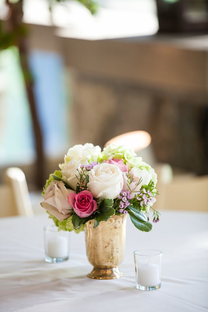Small floral centerpieces were displayed on the tables in golden vases. The flowers that made up the centerpieces were peonies, roses, viburnum and various others.