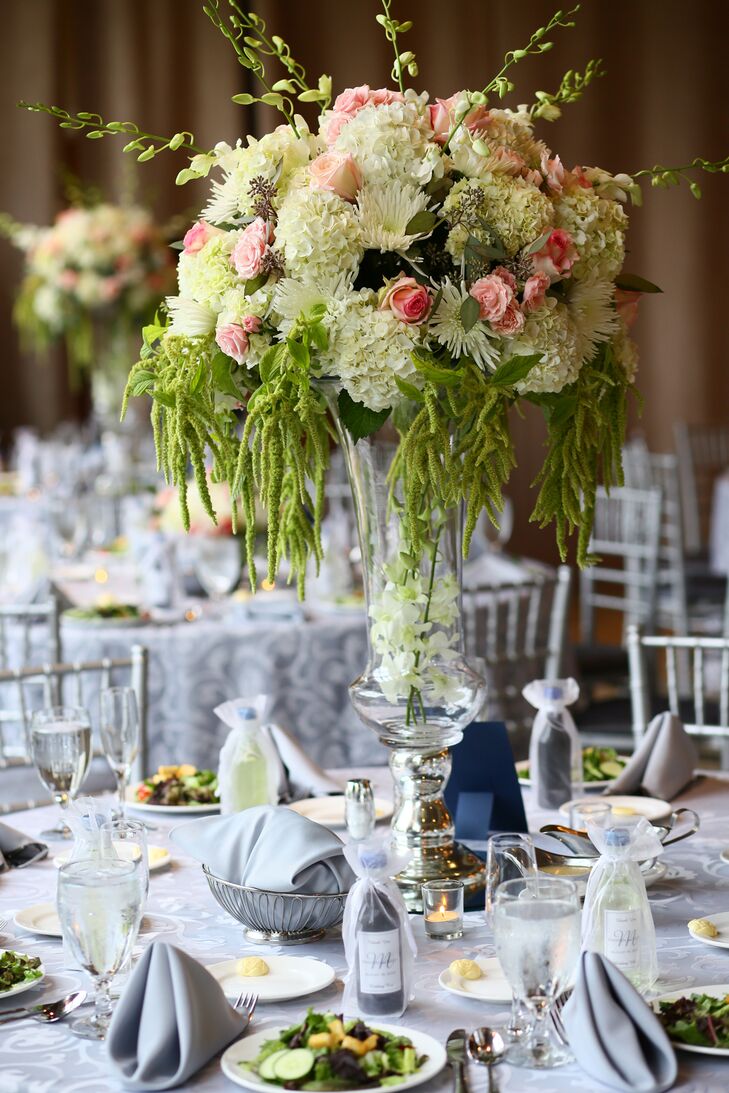 Arrangements of white hydrangeas, pink roses and assorted greenery towered over guests at each reception dinner table.