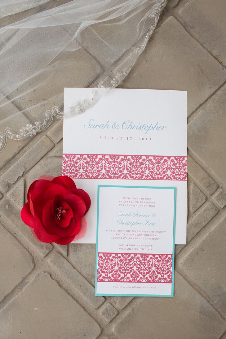 The white wedding invitations had a red patterned stripe going through the middle and was printed in teal text.