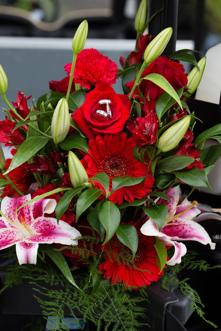 The bride's bouquet had red gerbera daisies, roses, carnations and alstroemeria with pink stargazer lilies arranged by Schmidt's Flowers.