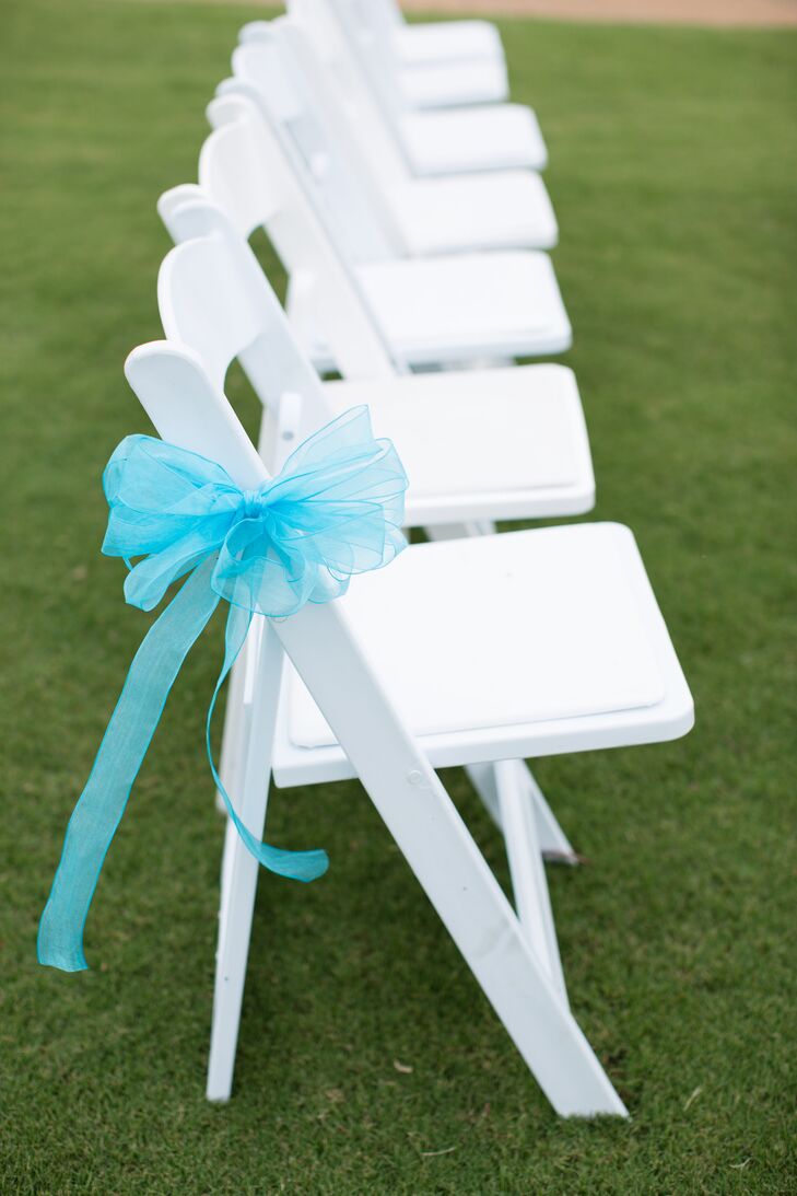 White Reception Chairs With Blue Ribbon