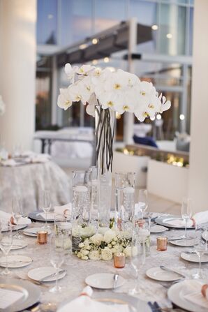 White Orchid Centerpieces in Tall Hurricane Vases