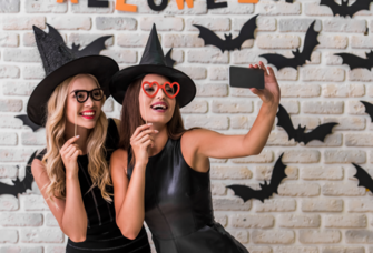 Two girls dressed in halloween costume taking selfie