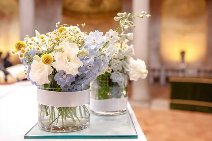 The centerpieces contained wildflowers, hydrangeas and craspedia in vintage glass jars.