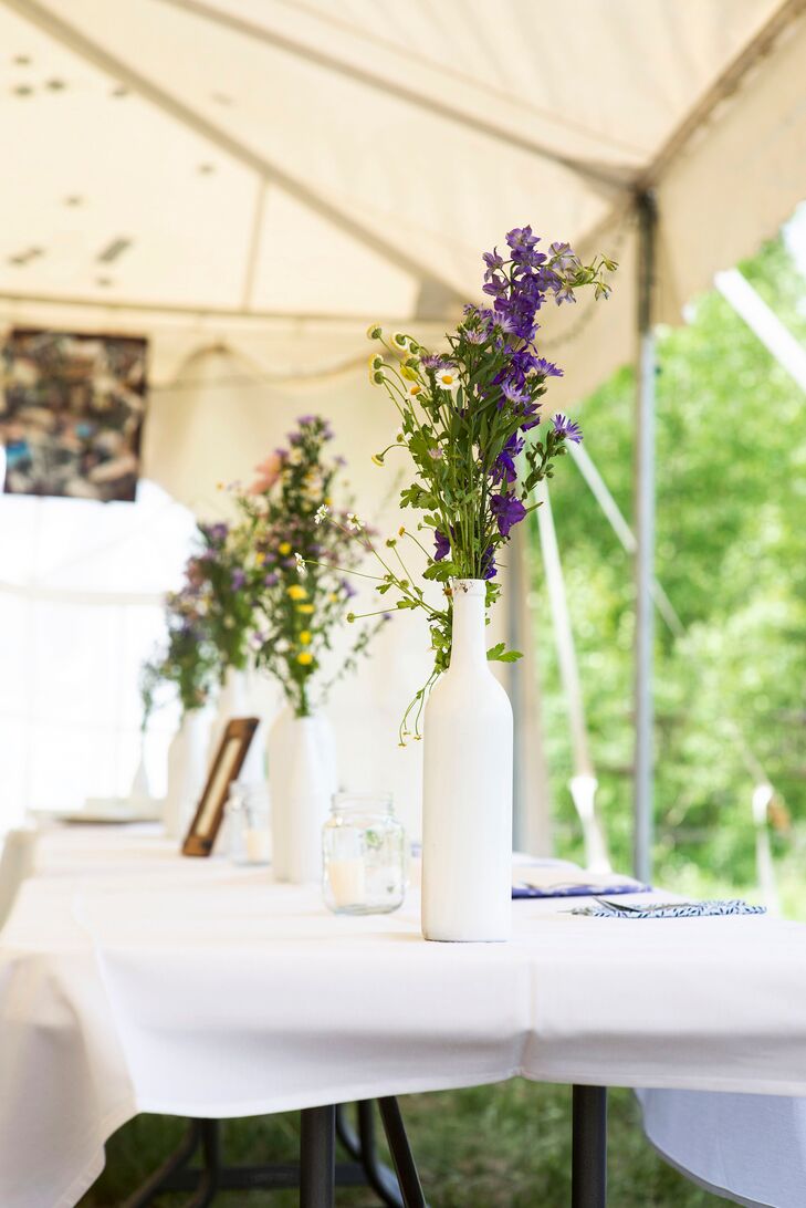 Elizabeth and Julie spray painted wine bottles white and filled them with wildflowers for the centerpieces. “The bright pinks, purples and yellows in our flowers were a great contrast to the white bottles,” Julie says.