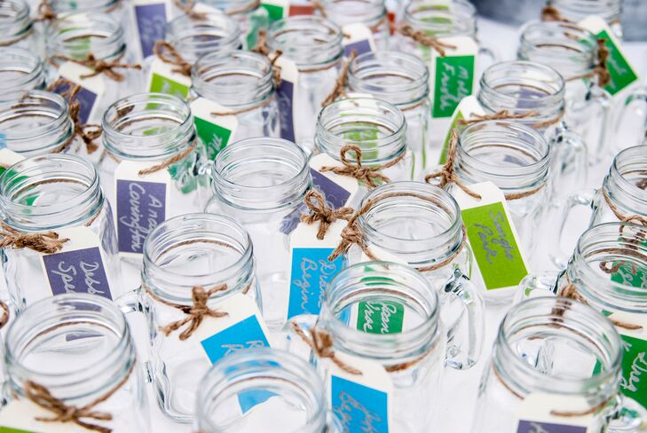 Elizabeth and Julie used mason jars as escort cards and favors for people to drink from that night and take home at the end of the night.