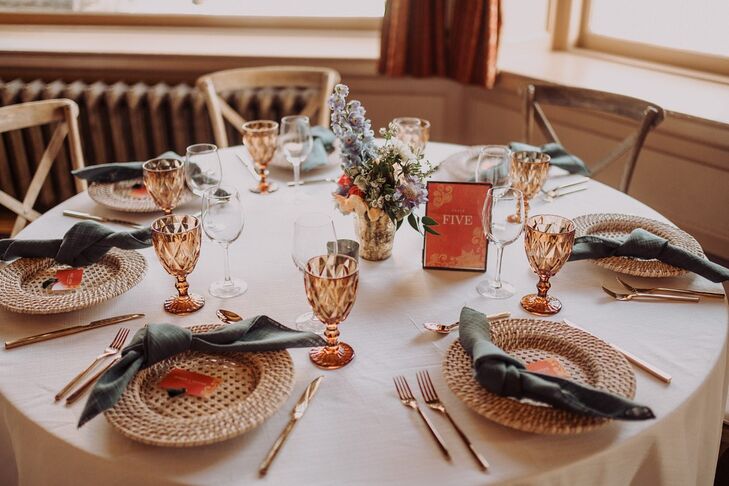 Elegant Round Table with Vintage Glassware, Woven Charger and Flower Centerpiece