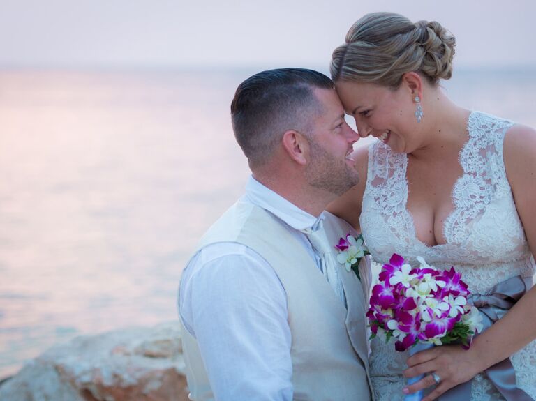 Smiling couple shares a sweet moment with the Barbados beach in the background. 