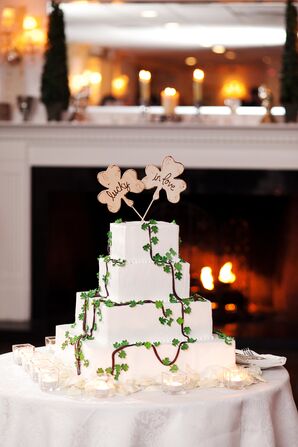 Four-Tier White Wedding Cake with Shamrock Decor