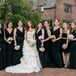 Joelle's bridesmaids wore stunning Noir by Lazaro dresses in black satin. the floor length dresses featured plunging V necklines and cowl backs. Her junior bridesmaid wore a black lace dress.