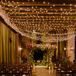 Romantic, Industrial Ceremony Site with String Lights and Flower Arch